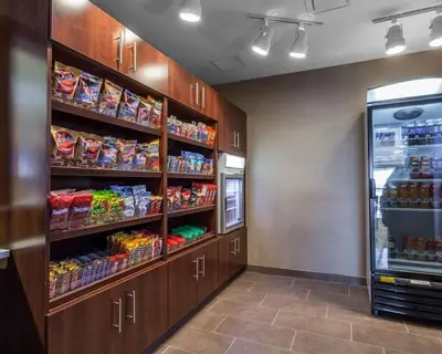 a store room with a refrigerator and shelves with food at Comfort Suites-Youngstown North in Youngstown
