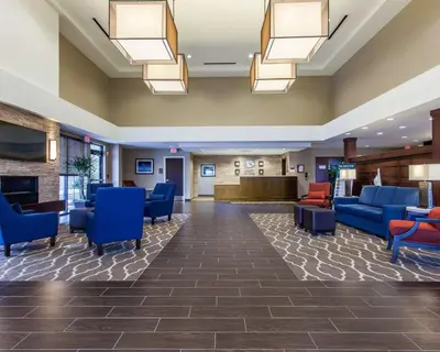 a lobby of a hospital with blue chairs at Comfort Suites-Youngstown North in Youngstown