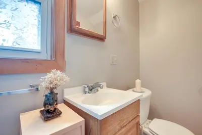 a bathroom with a sink and a toilet and a mirror at Quiet and Idyllic Studio Near Glen Helen Preserve in Fairborn