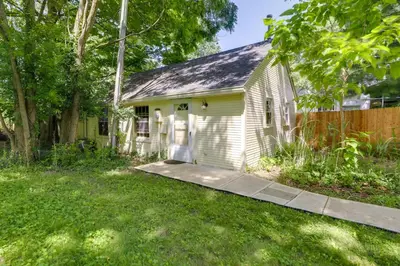 a small white house with a fence at Quiet and Idyllic Studio Near Glen Helen Preserve in Fairborn