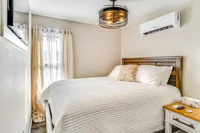 a bedroom with a bed and a nightstand with a bed sidx sidx sidx sidx at 15 Mi to Summit Lake State Park Updated Apt! in Hagerstown