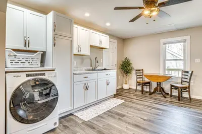 a kitchen with a washing machine and a table at 15 Mi to Summit Lake State Park Updated Apt! in Hagerstown