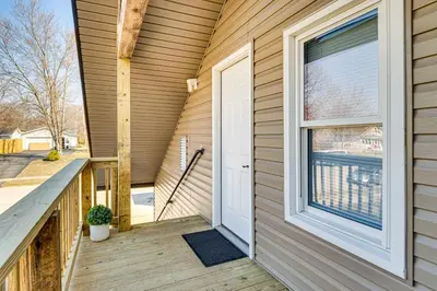 a porch with a white door and a window at 15 Mi to Summit Lake State Park Updated Apt! in Hagerstown