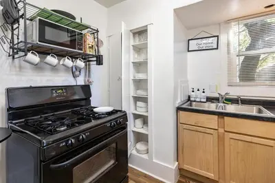 a kitchen with a stove and a sink at Kenmore Akron 3 bedroom 1 bath in Akron