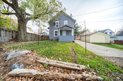 a house with a yard with a tree at Kenmore Akron 3 bedroom 1 bath in Akron