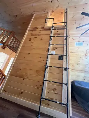 a loft bed in a tiny house at Cabin in the treetops! in Lancaster
