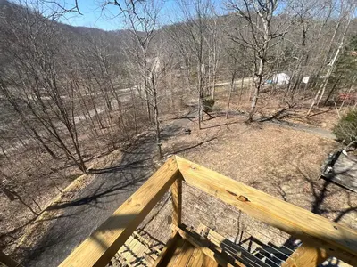a view from the top of a wooden porch with trees at Cabin in the treetops! in Lancaster