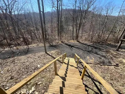 a wooden boardwalk in the middle of a forest at Cabin in the treetops! in Lancaster