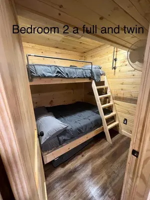 a room with two bunk beds in a tiny house at Cabin in the treetops! in Lancaster