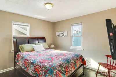 a bedroom with a bed and a flat screen tv at 2 Mi to UD Pet-Friendly Home with Fenced Yard! in Dayton