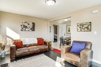 a living room with a leather couch and chairs at 2 Mi to UD Pet-Friendly Home with Fenced Yard! in Dayton