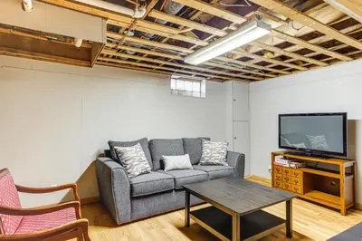 a living room with a couch and a tv at 2 Mi to UD Pet-Friendly Home with Fenced Yard! in Dayton