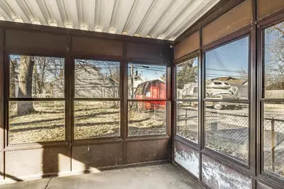 an empty room with windows with a train in the background at 2 Mi to UD Pet-Friendly Home with Fenced Yard! in Dayton