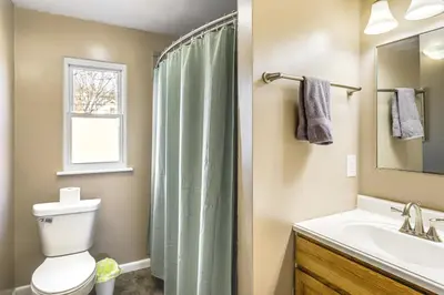 a bathroom with a toilet and a sink at 2 Mi to UD Pet-Friendly Home with Fenced Yard! in Dayton