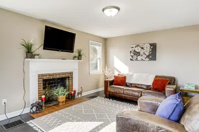 a living room with a couch and a fireplace at 2 Mi to UD Pet-Friendly Home with Fenced Yard! in Dayton