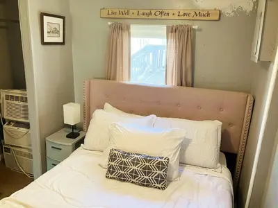 a bed with white pillows and a sign above it at 3 bedroom 1 bath in Cleveland in Cleveland