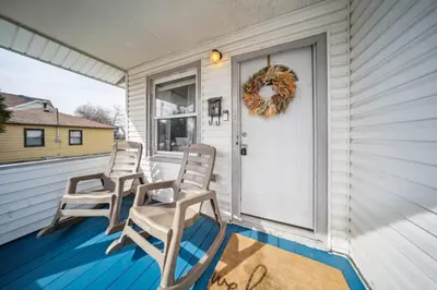 a porch with two chairs and a door at 3 bedroom 1 bath in Cleveland in Cleveland