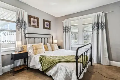 a bedroom with a bed and two windows at 3 bedroom 1 bath in Cleveland in Cleveland