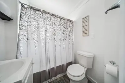 a bathroom with a toilet and a shower curtain at 3 bedroom 1 bath in Cleveland in Cleveland
