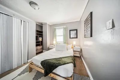 a bedroom with a bed and a large window at 3 bedroom 1 bath in Cleveland in Cleveland