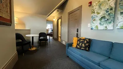 a living room with a blue couch and a table at Stone Gables Inn in Cleveland