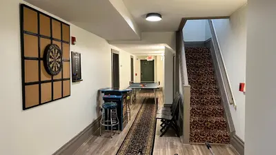 a hallway with a room with a clock on the wall at Stone Gables Inn in Cleveland