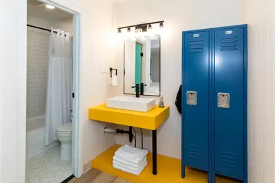 a bathroom with a sink and a toilet and a mirror at HomeField Inn in Sandusky