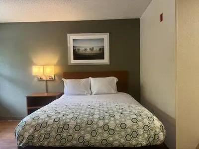 a bedroom with a bed and a picture on the wall at Siegel Select Cincinnati Sharonville in Cincinnati