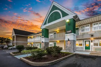 a hotel with a parking lot in front of it at Siegel Select Cincinnati Sharonville in Cincinnati