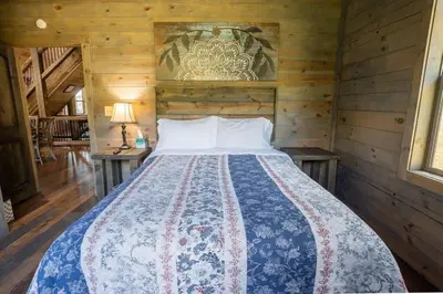 a bedroom with a bed in a wooden room at Serenity Ridge- Scenic Luxury Log Estate Getaway in McArthur