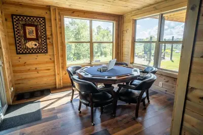 an office with a desk and chairs in a room with windows at Serenity Ridge- Scenic Luxury Log Estate Getaway in McArthur