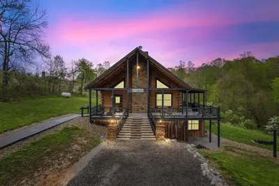 a house with a staircase leading up to it at Serenity Ridge- Scenic Luxury Log Estate Getaway in McArthur