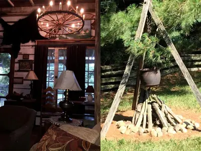 a living room with a fireplace and a chandelier at Charming Cabin Rental with a Hot Tub near Cedar Point and Lake Erie in Ohio in Bellevue