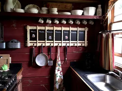 a kitchen with a sink and utensils on a wall at Charming Cabin Rental with a Hot Tub near Cedar Point and Lake Erie in Ohio in Bellevue