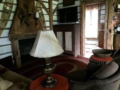 a lamp sitting on a table in a living room at Charming Cabin Rental with a Hot Tub near Cedar Point and Lake Erie in Ohio in Bellevue