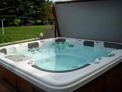 a jacuzzi tub sitting in a backyard at Charming Cabin Rental with a Hot Tub near Cedar Point and Lake Erie in Ohio in Bellevue