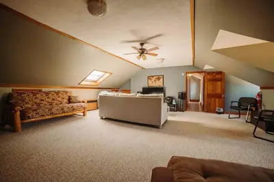 a living room with a couch and a ceiling fan at Majestic Home in Hocking wPool Jacuzzi Basketball in McArthur