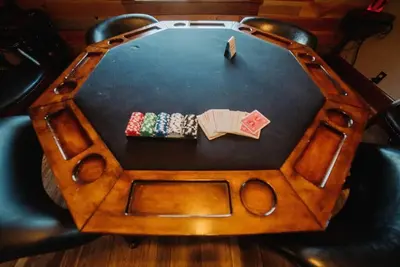 a table with a chair with two playing cards at Majestic Home in Hocking wPool Jacuzzi Basketball in McArthur