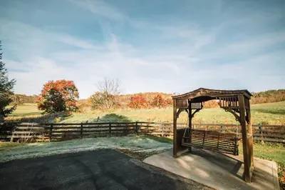 a wooden gazebo in a field with a fence at Majestic Home in Hocking wPool Jacuzzi Basketball in McArthur