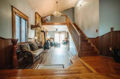 a living room with a staircase and a couch at Majestic Home in Hocking wPool Jacuzzi Basketball in McArthur