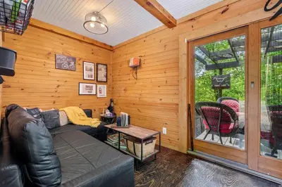 a living room with a couch and a window at Unique Dover Accommodation with a Hot Tub Perfect for Glamping in Ohio in Dover