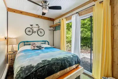 a bedroom with a bed and a bike on the wall at Unique Dover Accommodation with a Hot Tub Perfect for Glamping in Ohio in Dover