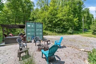 a group of chairs sitting in a yard at Unique Dover Accommodation with a Hot Tub Perfect for Glamping in Ohio in Dover
