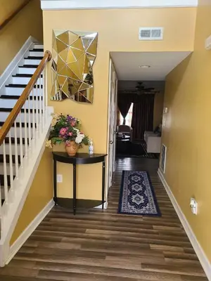 a hallway of a home with a staircase and a table with flowers at Charming Escape Haven in Lexington