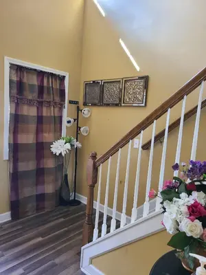 a stairway with flowers in a room with stairs at Charming Escape Haven in Lexington