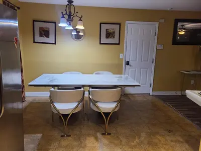 a dining room with a white table and chairs at Charming Escape Haven in Lexington