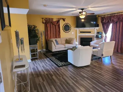 a living room with white furniture and a fireplace at Charming Escape Haven in Lexington