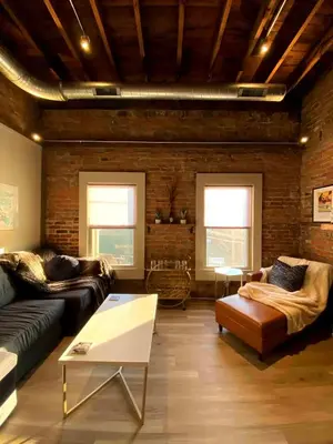 a living room with a couch and a table at Condo in OTR, Pendleton Art District in Cincinnati