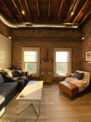 a living room with a couch and a table at Condo in OTR, Pendleton Art District in Cincinnati