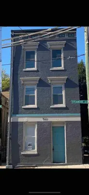 a blue brick building with a blue door at Condo in OTR, Pendleton Art District in Cincinnati